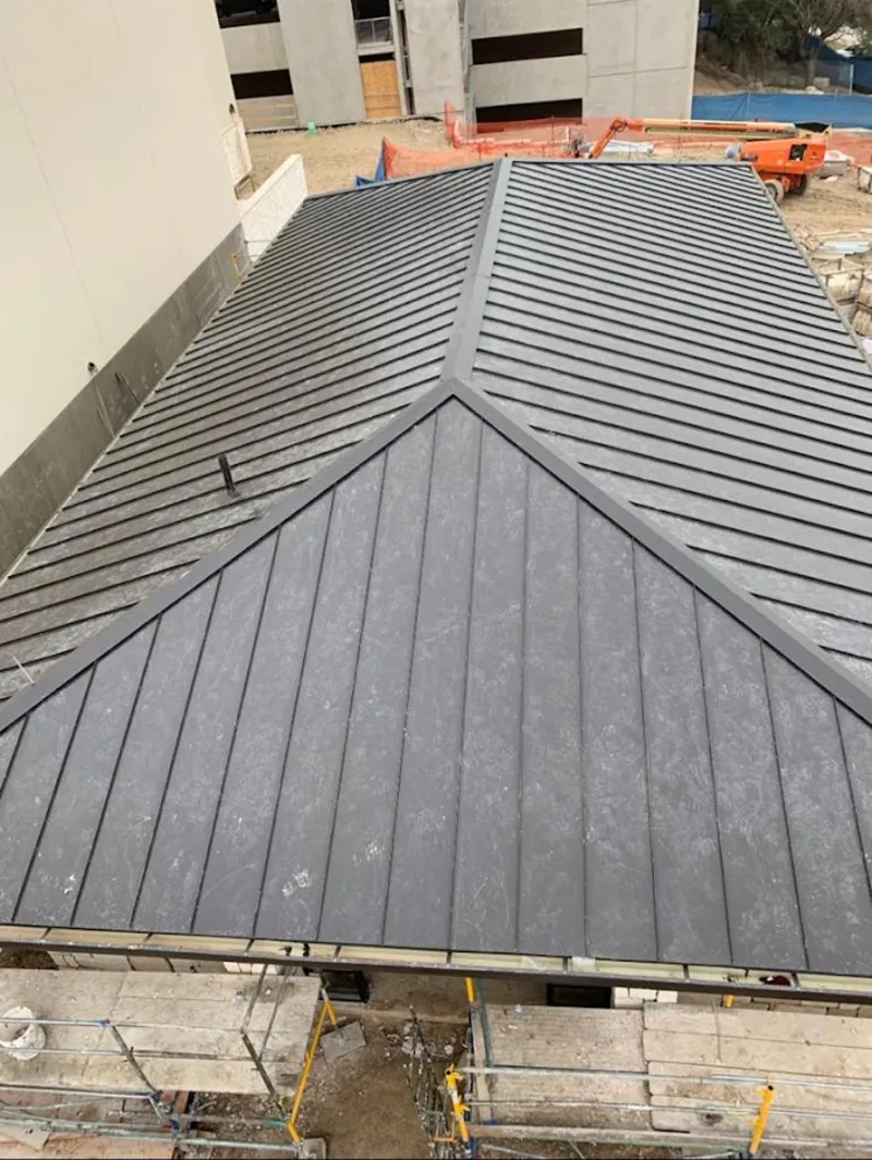 Commercial metal roof construction with crane equipment in Ashland